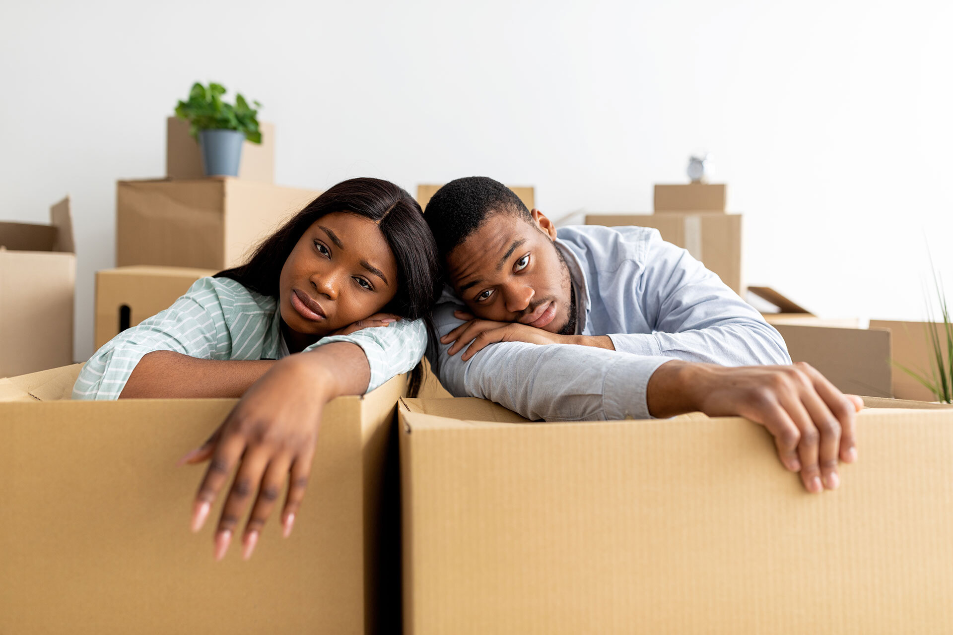 Two people stressed from moving that could be less stressful with moving tips